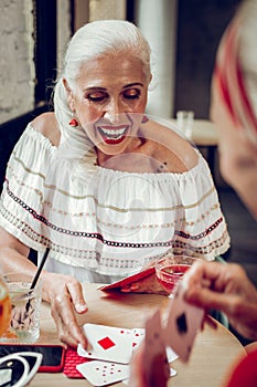 Positive blonde woman winning a card game