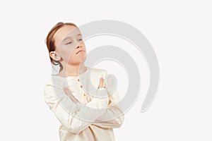 Positive boy crossing arms against white background with copy space