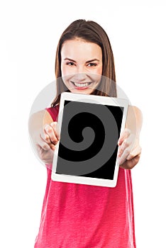 Positive brunette displaying a digital tablet