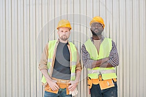 Positive builders relaxing on construction site