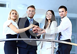 Positive business group standing on stairs of modern building