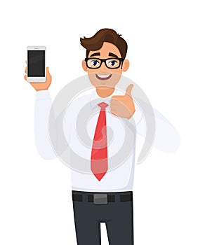 Positive business man showing new brand, latest smartphone. Man holding cell, mobile phone in hand and gesturing/making thumbs up.