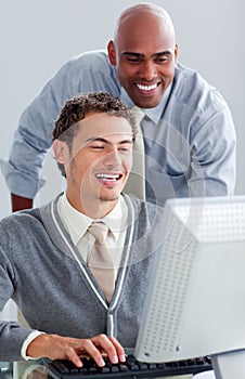 Positive business partners working at a computer