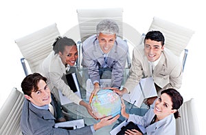 Positive business people holding a globe