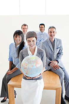 Positive business people holding a terrestrial glo photo