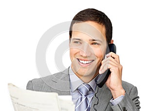 Positive businessman on phone holding a newspaper