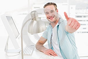 Positive businessman smiling with thumb up