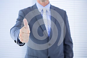 positive businessman smiling with thumb up