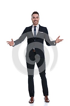 Positive businessman welcoming and smiling while standing