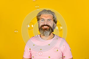 Positive. Carefree man soap bubbles. Summer vacation. Infantility concept. Happy playful bearded hipster and soap