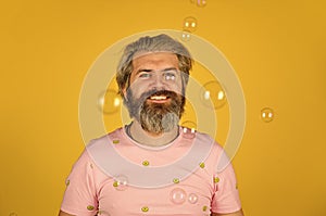 Positive. Carefree man soap bubbles. Summer vacation. Infantility concept. Happy playful bearded hipster and soap