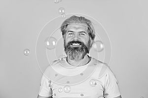 Positive. Carefree man soap bubbles. Summer vacation. Infantility concept. Happy playful bearded hipster and soap