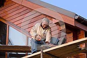 Positive carpenter with handsaw photo