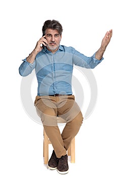 Positive casual man talking on his phone and gesturing