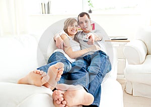 Positive caucasian couple lying on the couch