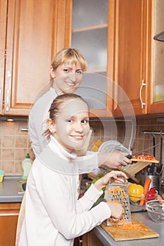 Positive Caucasian Family Preparing Food Together and Having Goo