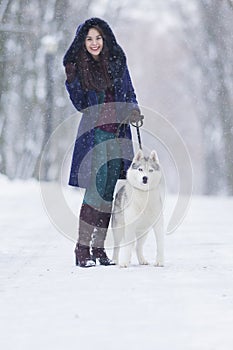 Positive Caucasian Woman Airing Her Husky Dog