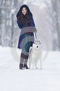Positive Caucasian Woman Airing Her Husky Dog photo