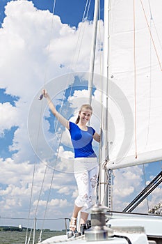 Positive caucasian Woman Sailing on yacht and Standing On Upper