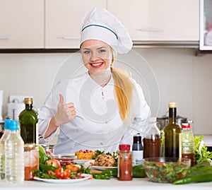 Positive chef posing with vegetable mix and cheese