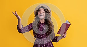 positive child with frizz hair recite book on yellow background