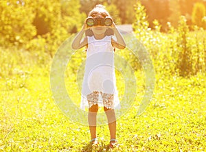 Positive child looks in binoculars