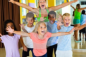 Positive children in dance studio smiling and having fun