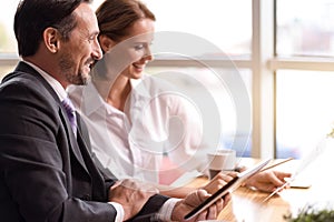 Positive colleagues sitting at the table