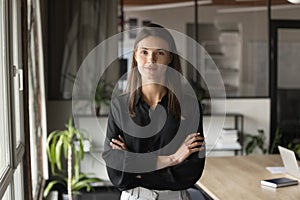 Positive confident beautiful business woman posing with hands crossed