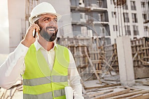 Positive construction inspector talking on phone