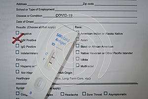 A positive corona covid-19 rapid test is on a test form