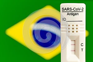 Positive corona test with a flag of Brazil in a background