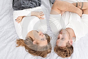 Positive couple lying in bed People. Love. Happy. Young. Adult. Romantic.