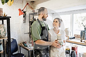 Positive couple of sculptors in aprons photo