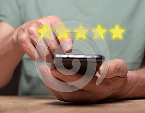 Positive customer experience concept. Phone user review and rating on mobile phone. Smartphone in male hands and 5 star