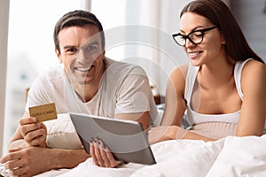 Positive delighted couple shopping online