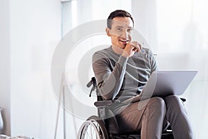 Positive delighted disabled man looking forward