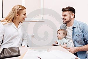 Positive delighted doctor looking at her patient