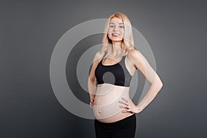 Positive delighted pregnant woman in the gym