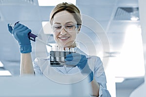 Positive delighted woman working in the medical lab