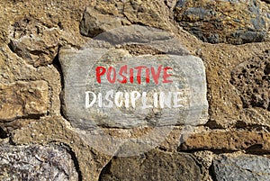 Positive discipline symbol. Concept words Positive discipline on beautiful big stone. Beautiful stone wall background. Business