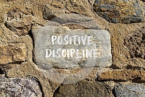 Positive discipline symbol. Concept words Positive discipline on beautiful big stone. Beautiful stone wall background. Business