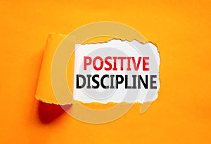 Positive discipline symbol. Concept words Positive discipline on beautiful white paper. Beautiful orange paper background.