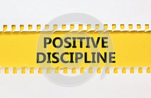 Positive discipline symbol. Concept words Positive discipline on beautiful yellow paper. Beautiful white table white background.