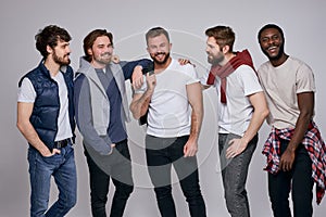 positive diverse men in casual urban style clothes posing at camera