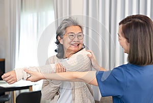 positive emotion senior woman doing physiotherapy that support from a young female nurse