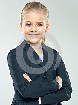 Positive emotional little business woman posing on isolated gra