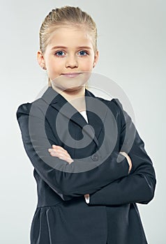 Positive emotional little business woman posing on isolated gra