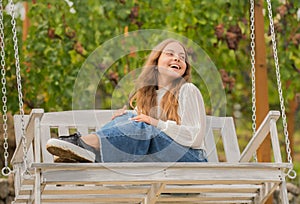 positive emotions. glad child on swing. kid swinging outdoor. teen girl having fun