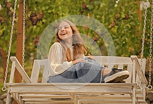positive emotions. glad child on swing. kid swinging outdoor. teen girl having fun